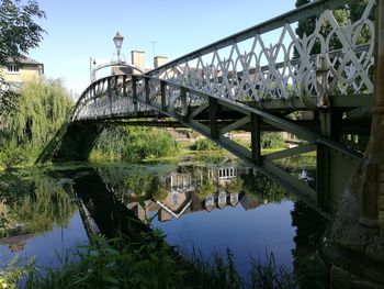 Arch bridge over river against sky
