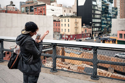 Rear view of man standing in city