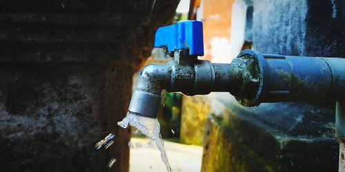 Close-up of water spraying from faucet 