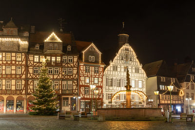 Illuminated building against sky at night