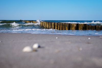 Surface level of sea against clear sky