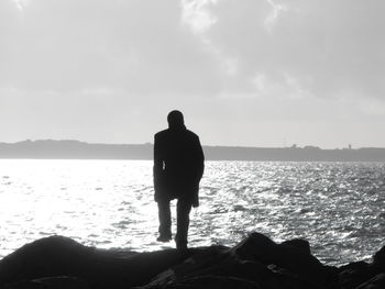 Silhouette of woman standing on beach