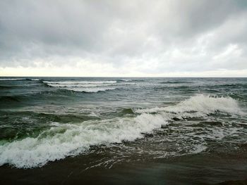 Scenic view of sea against storm clouds