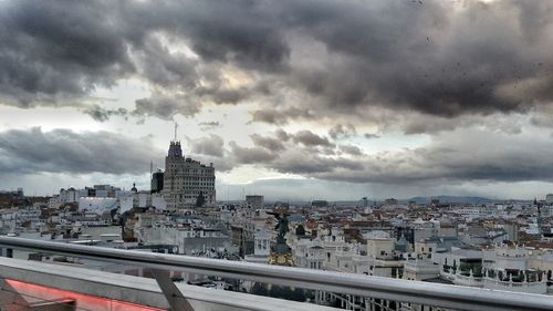 Cityscape against cloudy sky