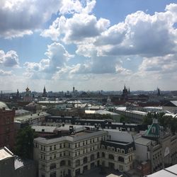 Buildings against cloudy sky