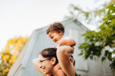 Father and son on baby outdoors