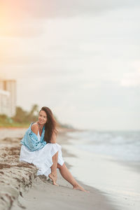 Young woman sitting on beach