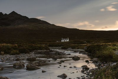 View of a lonely house and a little river near sligachan into the isle of skye, september 2019