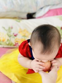 High angle view of cute baby on bed