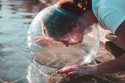 Reflection of man swimming in sea