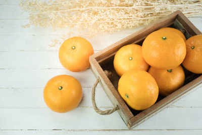 High angle view of oranges on cutting board