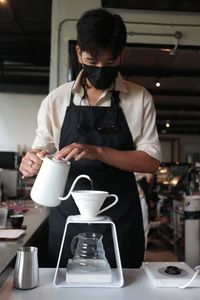 Rear view of man holding coffee cup