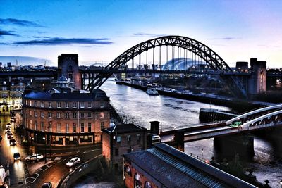 Bridge over river with city in background