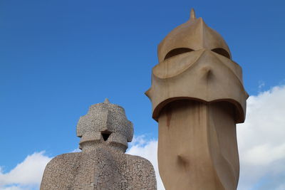 Low angle view of statue against blue sky