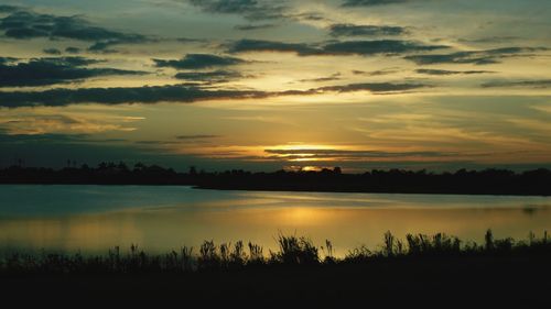 Scenic view of lake against orange sky