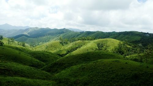 View of countryside landscape against cloudy sky