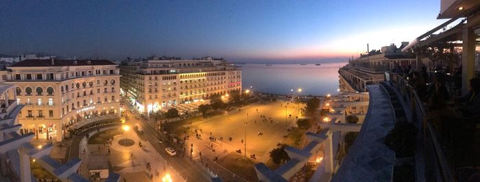 Aerial view of city lit up at night