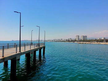 View of swimming pool by buildings against sky