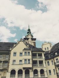 Low angle view of building against cloudy sky