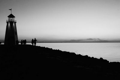 Black and white lighthouse with people