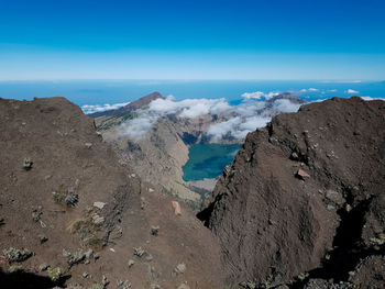 Panoramic view of volcanic landscape against blue sky
