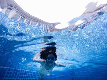 Full length of girl swimming in pool