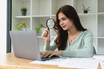 Businesswoman using digital tablet at office