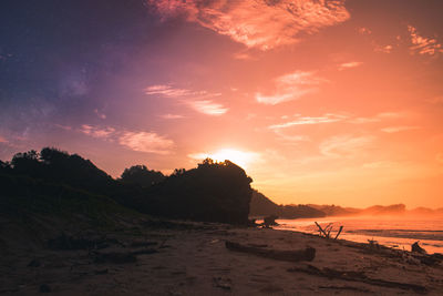 Scenic view of beach against sky during sunset