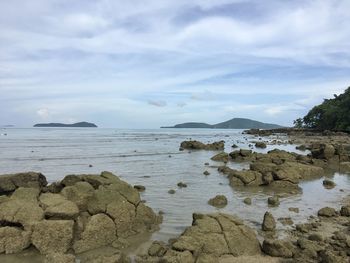 Rocks on beach against sky