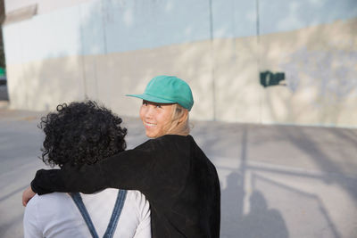 Rear view of man standing against wall