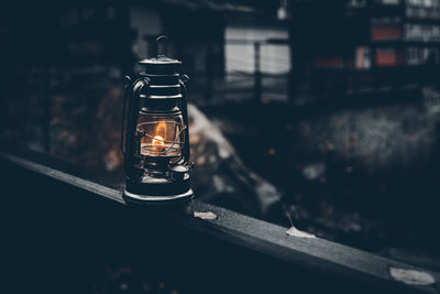 Close-up of illuminated light bulb on table