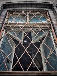 Low angle view of old building seen through window