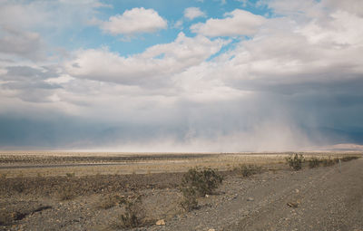 Scenic view of landscape against cloudy sky at death valley national park