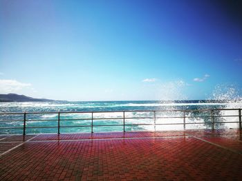 Scenic view of sea against blue sky