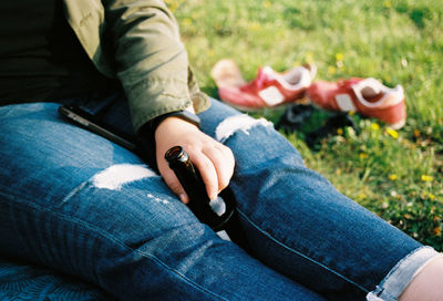 Low section of man sitting on grass