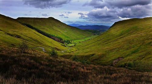 Scenic view of mountains against cloudy sky
