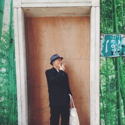 Woman standing on tree trunk