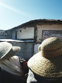 Hat on stone wall against sky