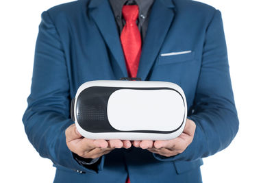 Midsection of man holding mobile phone