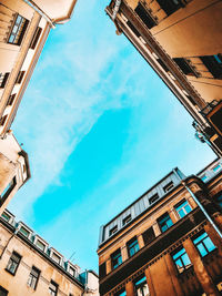 Low angle view of buildings against blue sky