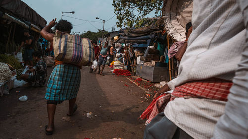 Rear view of people walking on street