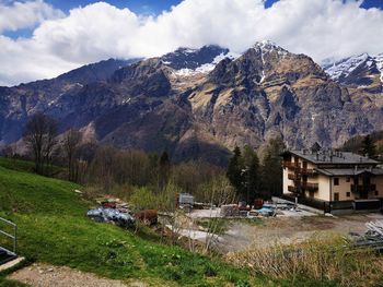 Scenic view of houses and mountains against sky