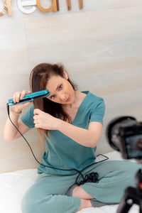 Portrait of a smiling young woman sitting at home