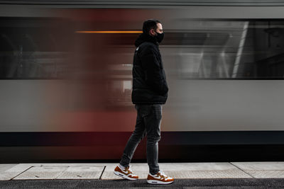 Full length of man standing at railroad station