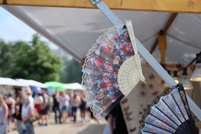 Close-up of floral pattern hand fans for sale at market