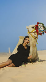 Girl with camel in the desert