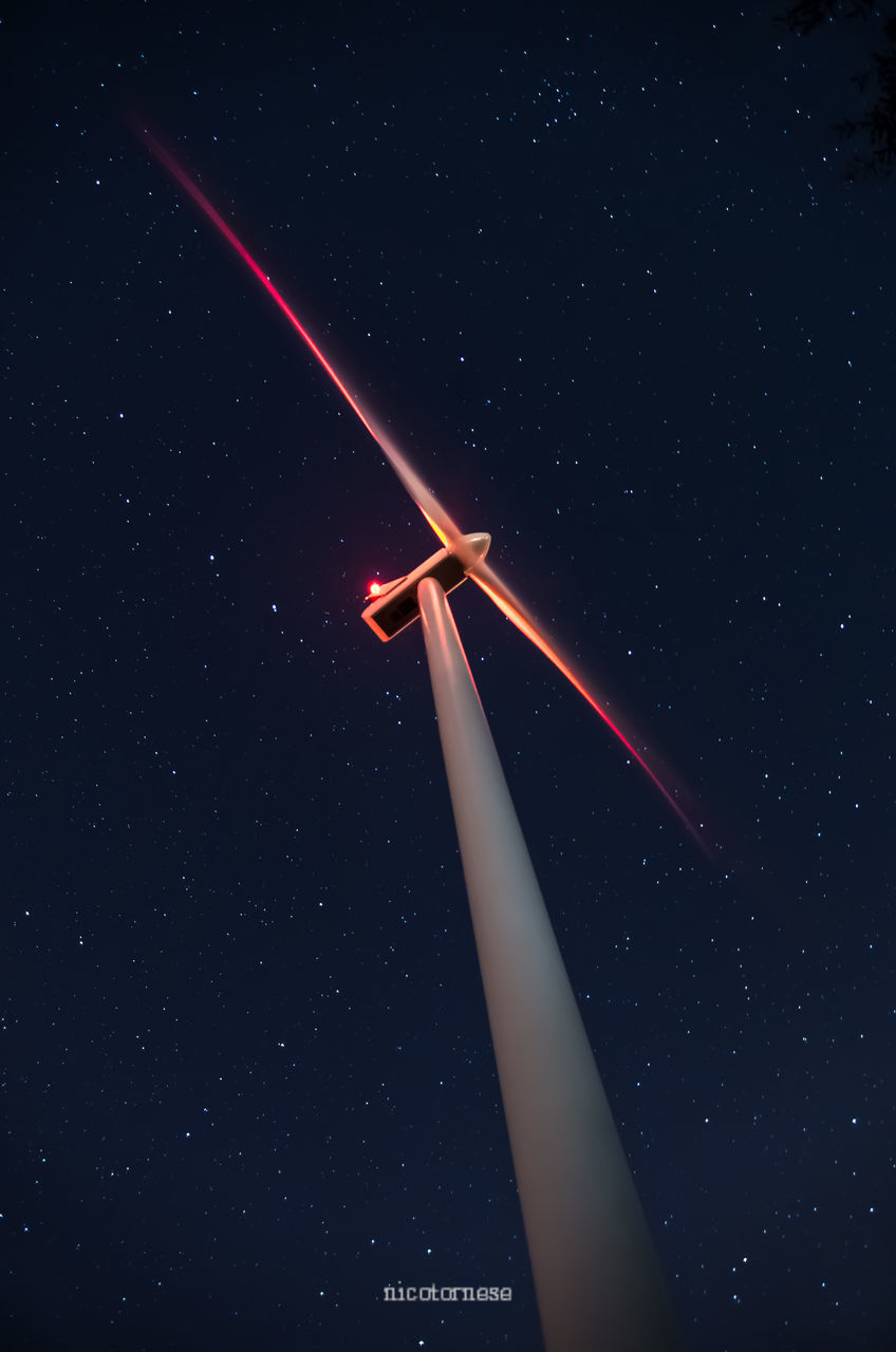 LOW ANGLE VIEW OF WIND TURBINE AT NIGHT