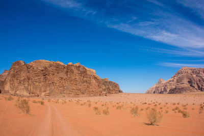 Rock formations in desert against blue sky