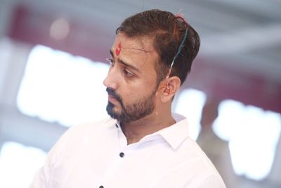 Young man with tilaka on forehead looking away