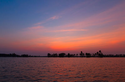 Scenic view of sea against romantic sky at sunset